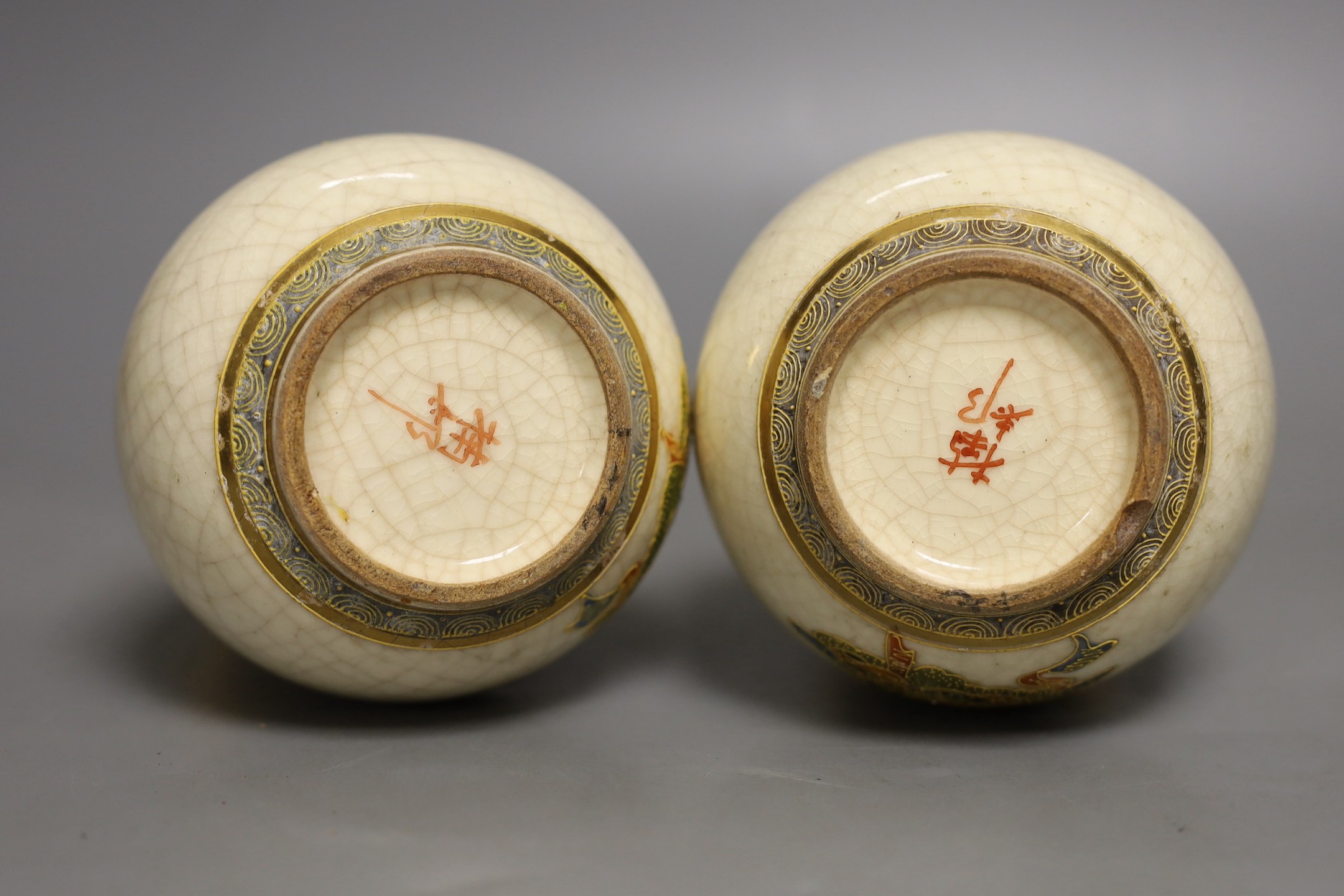 A pair of Japanese Satsuma vases, signed, 17 cms high.